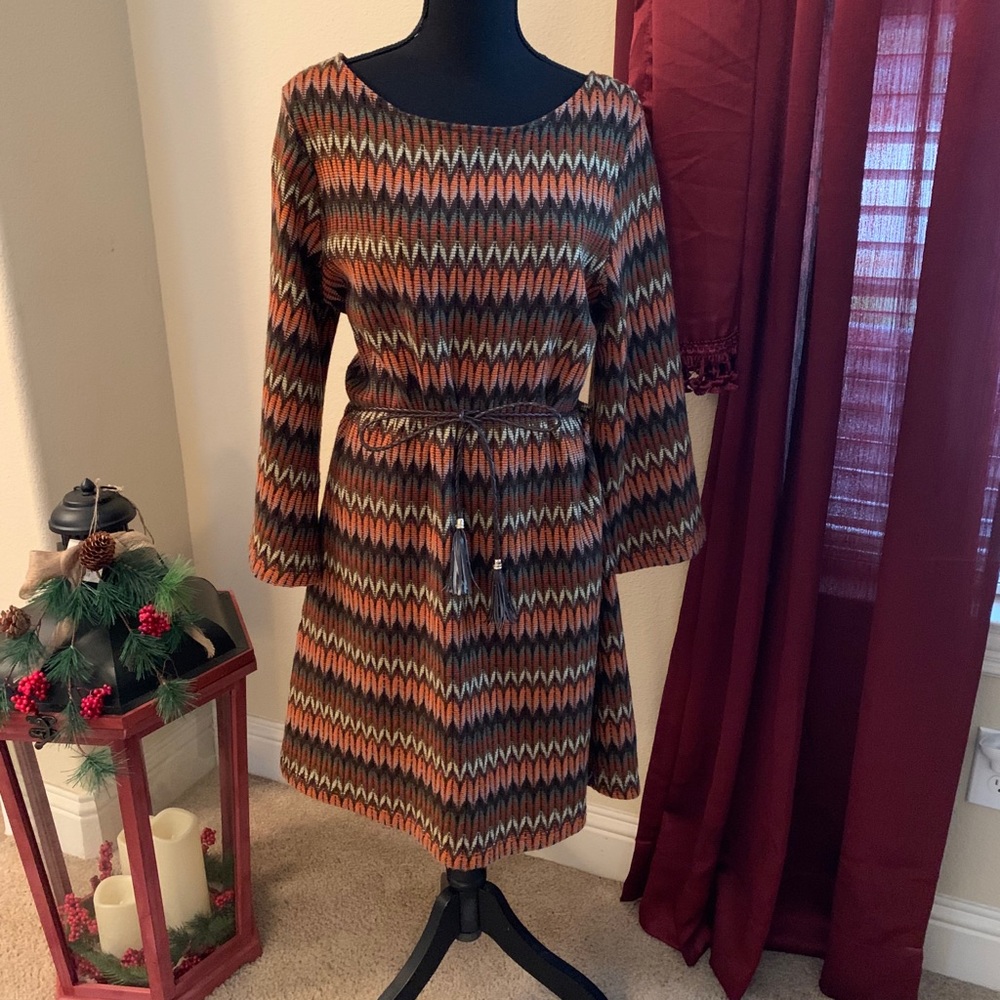 Adorable dress with leather-like fringe belt.